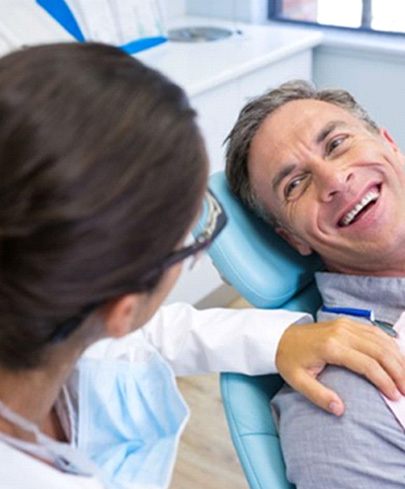 a patient smiling while chatting with their endodontist