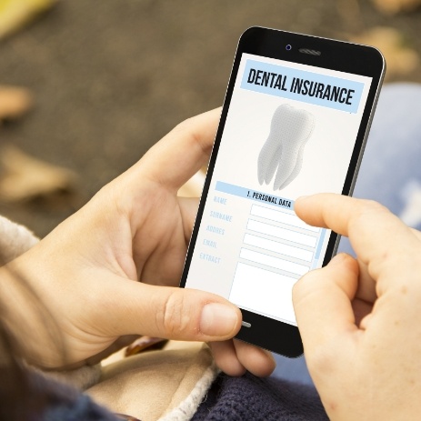Patient reviewing dental insurance forms on smart phone