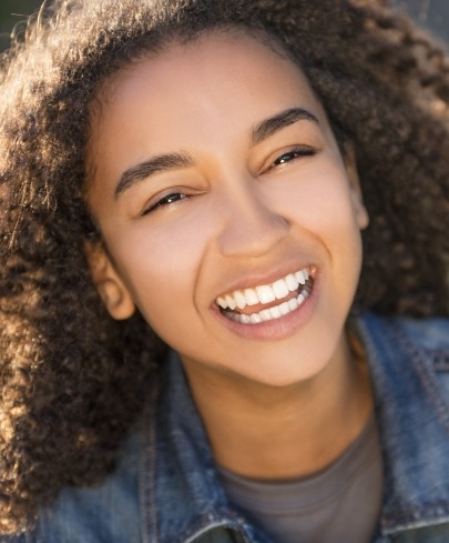 Preteen smiling after receiving endodontics for children