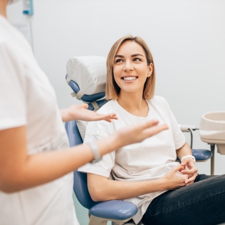 Endodontist describing retreatment aftercare procedure to smiling patient