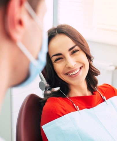 Woman smiling at dentist after endodontic surgery