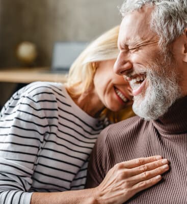 Man and woman smiling after root canal therapy