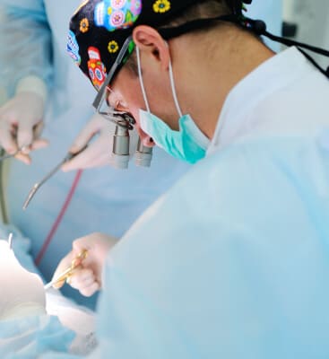 Endodontist performing endodontic surgery