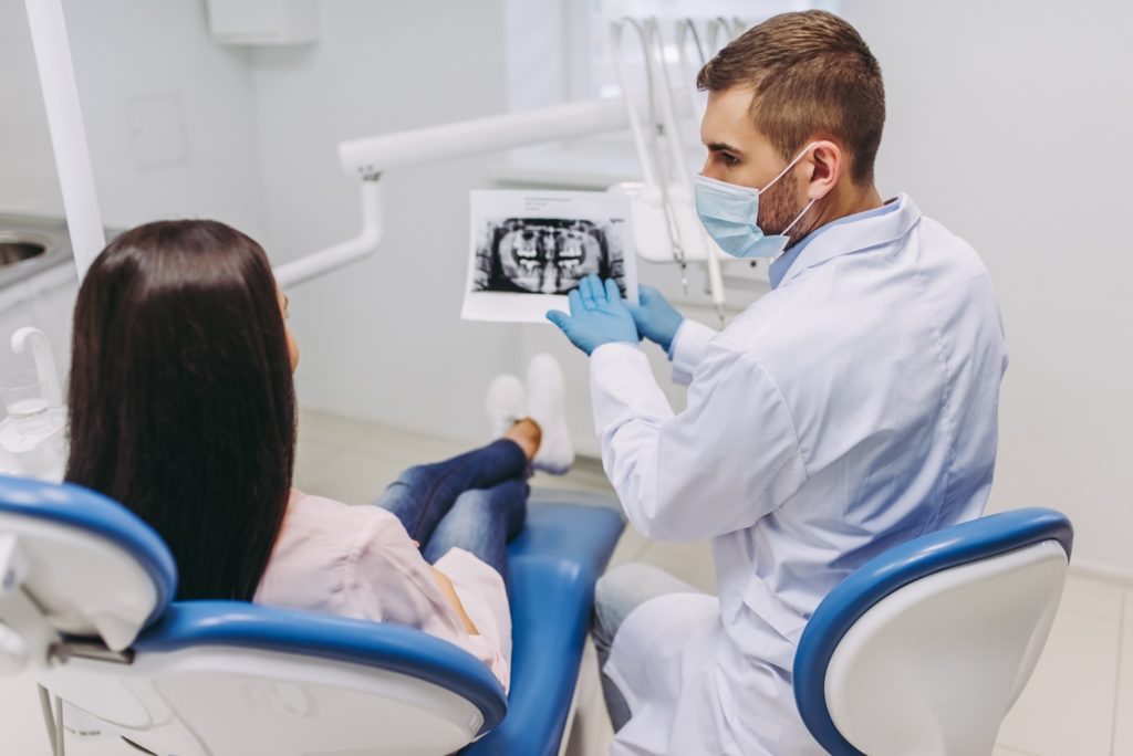 Dentist explaining X-ray to patient