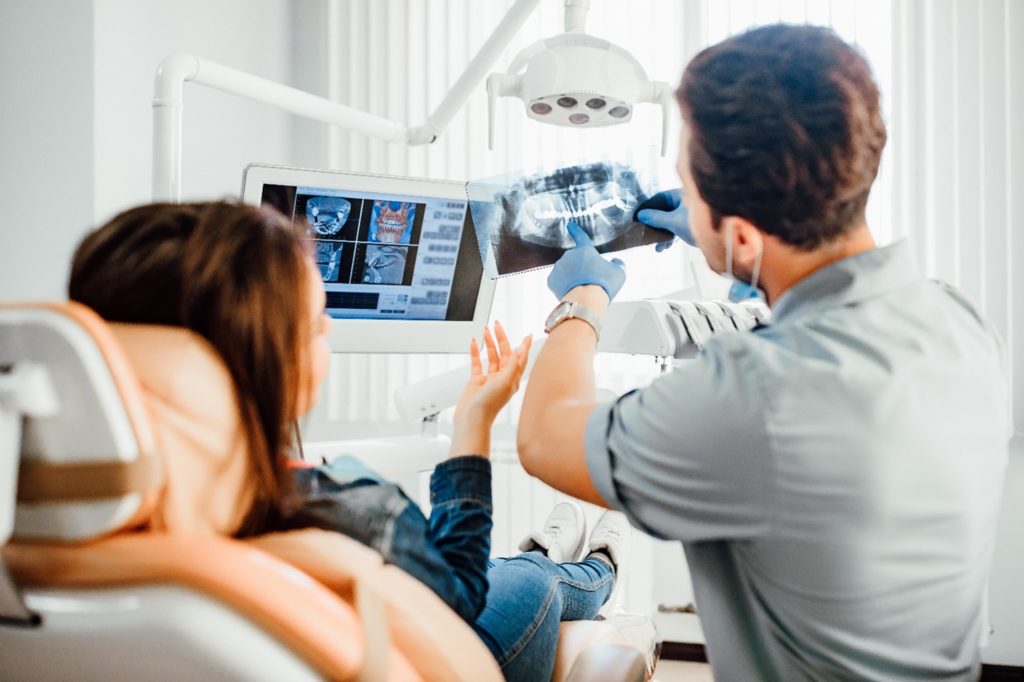 Dentist explaining X-ray to patient