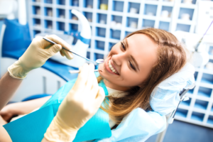 a patient smiling while visiting her dentist