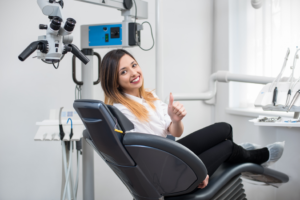 a patient smiling while visiting her endodontist 